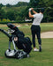 Stewart X10 Follow electric push cart and a golf player